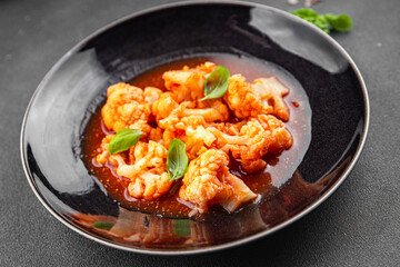 cauliflower tomato sauce casserole stewed vegetable healthy eating cooking appetizer meal food snack on the table copy space food background rustic top view 