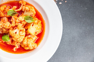 cauliflower tomato sauce casserole stewed vegetable healthy eating cooking appetizer meal food snack on the table copy space food background rustic top view 