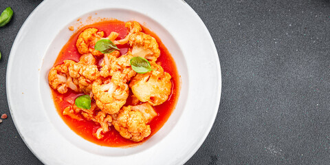 cauliflower tomato sauce casserole stewed vegetable healthy eating cooking appetizer meal food snack on the table copy space food background rustic top view 