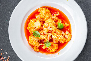cauliflower tomato sauce casserole stewed vegetable healthy eating cooking appetizer meal food snack on the table copy space food background rustic top view 