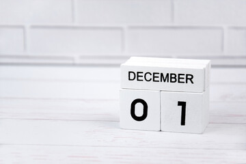 White wooden perpetual calendar showing the 1st of December.