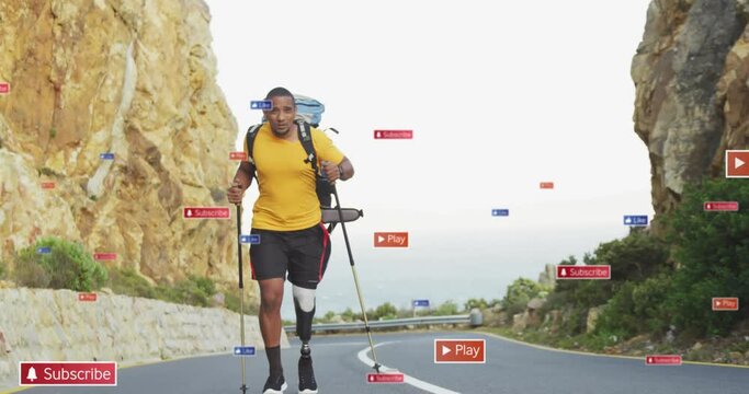 Animation of social media icons over african american man with prosthetic leg trekking on the road