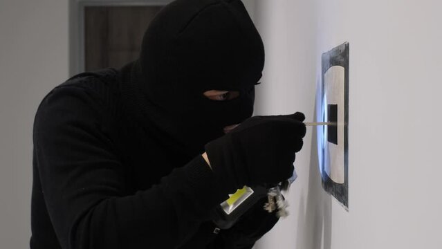 A burglar breaks into a safe. Danger of house robbery