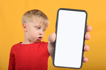 cute boy child shows smartphone with blank white screen