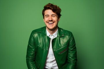 Portrait of a happy man in his 20s sporting a stylish leather blazer against a pastel green background. AI Generation