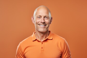 Portrait of a grinning man in his 40s wearing a sporty polo shirt against a pastel orange background. AI Generation