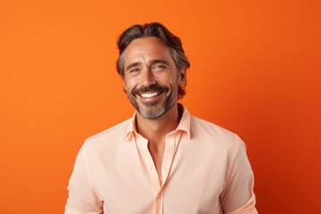 Portrait of a blissful man in his 40s wearing a simple cotton shirt against a pastel orange background. AI Generation
