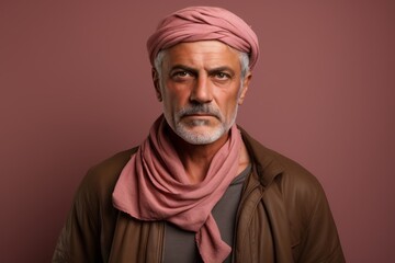 Fototapeta premium Portrait of a content man in his 50s wearing a versatile buff against a pastel brown background. AI Generation