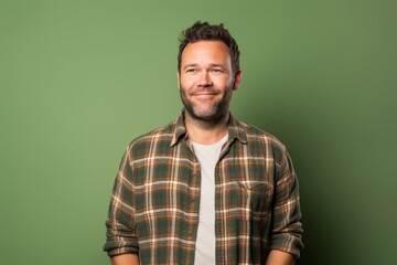 Portrait of a joyful man in his 30s wearing a comfy flannel shirt against a soft green background. AI Generation - obrazy, fototapety, plakaty