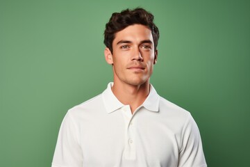 Portrait of a blissful man in his 20s wearing a breathable golf polo against a soft green background. AI Generation