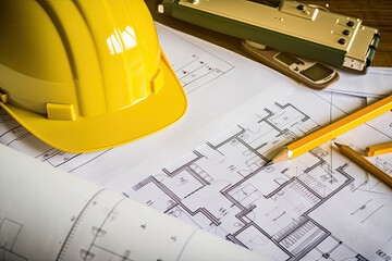 construction helmet and blueprint, Close up of architecture project of building and yellow helmet over design equipment. business, architecture, design and work.