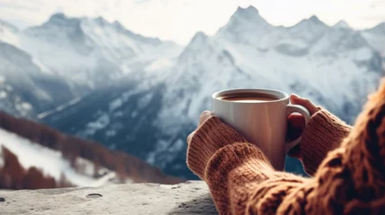 Foto op Plexiglas Hands woman holding hot drink cup relaxes in winter season with mountain view background. © Oulaphone