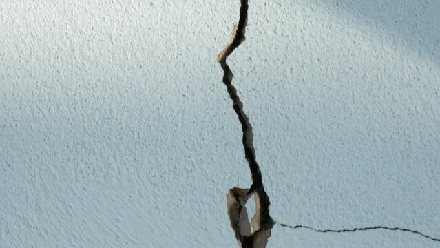 Cracks in the cement wall White cement of buildings damaged by earthquakes