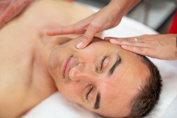 Fototapeta na wymiar Non-surgical facelift for man - Italian modeling massage Gym