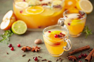 Homemade hot alcohol apple cider punch with cinnamon sticks, anise star and spices