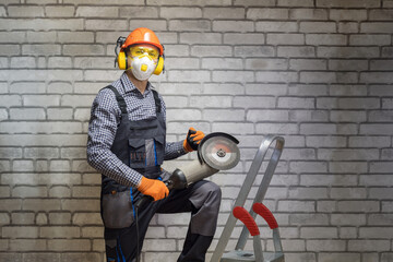 Worker is using angle grinder. Construction concept. Builder wearing in personal protective...