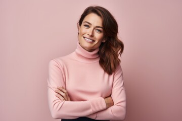 Portrait of a satisfied woman in her 30s wearing a classic turtleneck sweater against a pastel or...