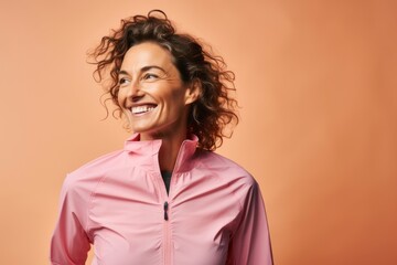Portrait of a jovial woman in her 40s sporting a technical climbing shirt against a pastel or soft colors background. AI Generation