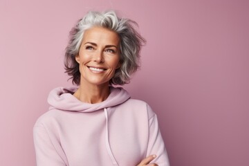 Fototapeta premium Portrait of a blissful woman in her 50s dressed in a comfy fleece pullover against a pastel or soft colors background. AI Generation