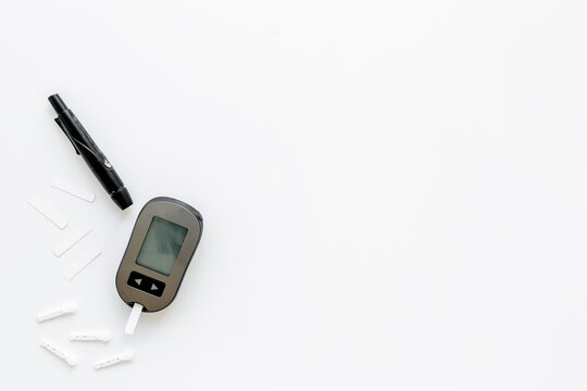 Medical device and diabetes concept - blood glucose meter with lancets