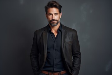Obraz premium Portrait of a satisfied man in his 40s sporting a stylish leather blazer against a minimalist or empty room background. AI Generation