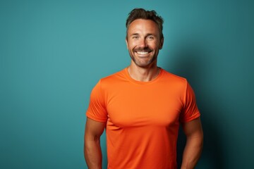 Fototapeta premium Portrait of a grinning man in his 30s wearing a moisture-wicking running shirt against a solid color backdrop. AI Generation