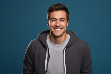 Portrait of a smiling man in his 30s wearing a zip-up fleece hoodie against a solid color backdrop. AI Generation - obrazy, fototapety, plakaty