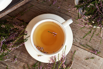 Wild heather or Calluna vulgaris flowers in a cup of herbal tea