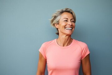Portrait of a smiling woman in her 40s sporting a breathable mesh jersey against a solid pastel color wall. AI Generation