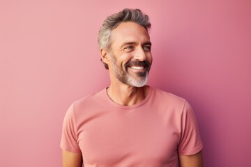 Obraz premium Portrait of a happy man in his 40s donning a trendy cropped top against a solid pastel color wall. AI Generation