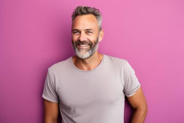 Fototapeta na wymiar Portrait of a happy man in his 40s donning a trendy cropped top against a solid pastel color wall. AI Generation