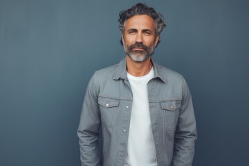 Fototapeta premium Portrait of a tender man in his 40s sporting a rugged denim jacket against a solid pastel color wall. AI Generation