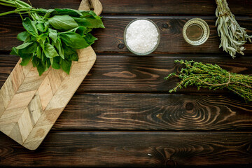 Bunches of fresh spicy herbs on wooden board for cooking, top view