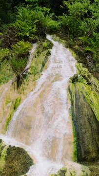 View from above of unique steaming Bilawa Hot Waterfall. Davao de Oro, Philippines. Vertical view.