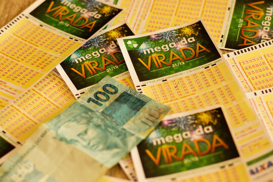 Brazilian lottery receipts Mega Sena da Virada and a hundred reais note.  Photo taken in Mogi das Cruzes - SP in Nov 10 2023