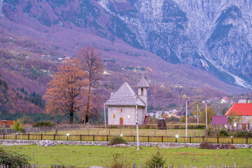 Fototapeta na wymiar albania theth national park and stone church among mountains blue sky over valley
