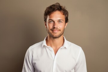 Portrait of a satisfied man in his 30s wearing a simple cotton shirt against a light wood minimalistic setup. AI Generation