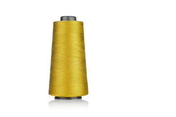 spool of industrial thread yellow color, texture of thread on a white background