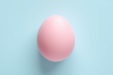 Minimal fashion concept with a pink egg on light blue pastel background