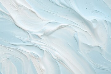 Smudged cream texture on pastel blue backdrop
