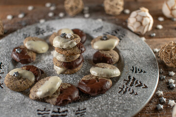 Poppy seed cookies  with chocolate glaze for christmas on a silver plate