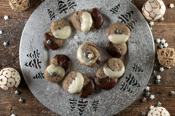 Poppy seed cookies  with chocolate glaze for christmas on a silver plate