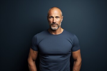 Fototapeta premium Portrait of a content man in his 40s donning a trendy cropped top against a plain cyclorama studio wall. AI Generation