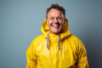 Portrait of a smiling man in his 50s wearing a vibrant raincoat against a crisp minimalistic living room. AI Generation