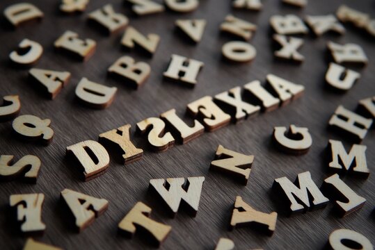 Closeup image of text DYSLEXIA surrounded by scattered alphabet.