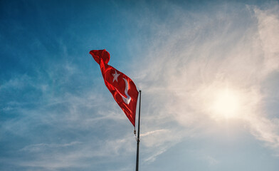 Red Turkish flag against blue sky