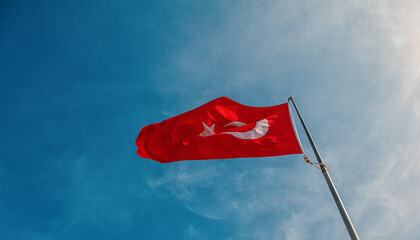Red Turkish flag against blue sky