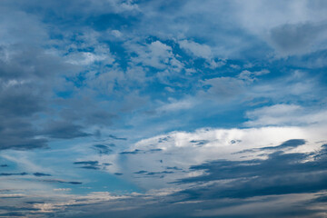 Naklejka na ściany i meble A photo capturing a blue sky filled with white and gray clouds.