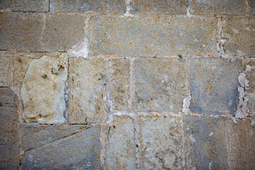 Background old wall made of porous stones of the mountainous area. Wall of an ancient church.