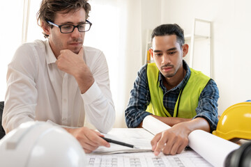Engineers team and owner discuss check and review the blueprint of construction. Contractor...